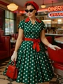 Abito vintage a pois verde scuro con revers rosso e cintura a fiocco in un diner - S / Verde Scuro