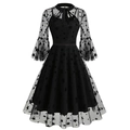 Close-up detail of gothic star mesh embroidery and flared sleeves on a black dress - Star