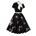 Detail of vintage black dress featuring a white bow neckline and floral print pattern - S / Black