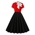 Detail of red and black retro dress featuring a white stand collar and large bow decoration - S / Red