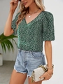 Detail of V-neck floral top with puff sleeves and green fabric texture in street style - XS / Green