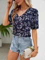 Close-up of elegant V-neck floral blouse paired with denim shorts and a white chain handbag - XS / Sapphire Blue