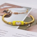 Handmade Miyuki bead bracelet with golden beads and white heart motif charm - Yellow