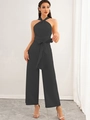 Close-up of halter neck jumpsuit with cross neckline and waist tie-belt detail - S / Black