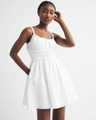 Detailed close-up of white smocked waist and ruffled straps on a sleeveless summer dress - S / White