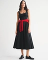 Detail view of slim fit black midi dress with square neck and red sweater waist accent - S / Black
