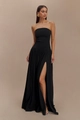 Detailed view of backless black strapless maxi dress featuring ruched bodice and side slit - XS / Black