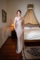 Detail of elegant champagne satin evening gown with one-shoulder drape and glossy texture - S / Gray