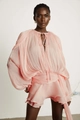 Close-up of pleated texture on a pink puff sleeve dress with waist tie and ruffles - S / Pink