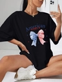 Oversize black round neck T-shirt with American flag bow and Girly print on model - S / Black