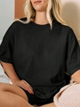 Détail du t-shirt noir oversize en coton avec une coupe ample et un col rond classique - S / Noir