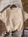 Minimalist beige loose fit crewneck cotton T-shirt hanging on a wooden hanger with aesthetic props - S / Apricot
