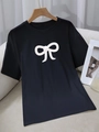 Women's black crew neck cotton T-shirt featuring a stylish white bow print detail - S / Black