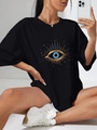 Dames oversized zwart katoenen T-shirt met een goud en blauwe evil eye grafische print - S / Zwart