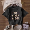 Black cotton T-shirt with I AM A CHILD OF GOD print on a rustic wooden background - S / Black