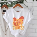 White cotton t-shirt featuring red heart and Love Like Jesus print in a casual knotted style - White