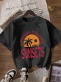 Black crewneck T-shirt with sunset palm tree print on wooden background - S / Black