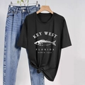 Detail of black cotton T-shirt featuring white fish print and stylish front hem knot - S / Black
