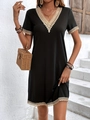 Detail of V-neckline and beige lace trim on a black French style knit A-line dress - S / Black