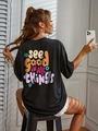 Detail of black cotton T-shirt featuring colorful floral and typography back print - S / Black
