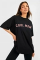 Detail view of the pink COOL MOM slogan print on a loose black cotton t-shirt - S / Black