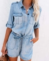 Detail of light blue denim romper featuring front utility pockets and black buttons - S / Blue