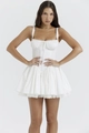 Close-up of white corset dress featuring a bow-tie bust and lace-trimmed ruffled hemline - S / White