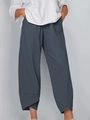 Detail view of charcoal grey cropped pants featuring a unique tulip hem design and elastic waist - Dark Gray