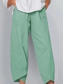 Detailed close-up showing the unique overlapping hem design and soft mint fabric of the pants - Light Green