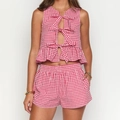 Detail of red gingham crop top featuring three front bows and delicate ruffle hemline - S / Red