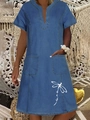 Close-up of V-neck denim dress featuring dragonfly print and functional large pockets - Dark Blue Dragonfly Print