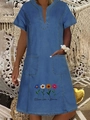 Detail of V-neck denim dress featuring large pockets and colorful daisy flower print - Dark Blue Colorful Floral Print