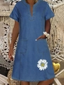 Detail of blue denim style V-neck dress with pockets and white daisy print on the hem - Dark Blue Single Daisy Print