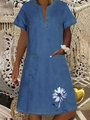 Detail view of denim dress featuring V-neckline and white daisy floral print on pocket - Dark Blue Daisy Print With Large Pockets