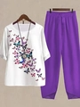 Close-up of women's round neck white top with butterfly print and purple loose trousers - S / Top And Bottom / White and Purple Butterfly Print