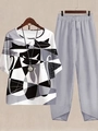 Detail of grey pants with tulip hem and abstract cat print top on wooden hanger - S / Top And Bottom / Abstract Cat Print