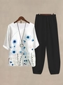 Detail of floral print top with wide-leg cropped pants and silver pendant necklace - S / Top And Bottom / Blue Ink Floral (Style 41)