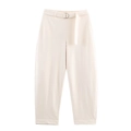Detailed view of high-waisted cream trousers with matching D-ring belt and tapered cuffs - XS / Bottoms / Pure White