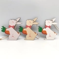 Three wooden Easter bunnies in pink, natural, and white colors with jute ropes - Colorful Bowtie Rabbit With Carrot Style (HF10804)