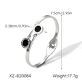 Detail view of steel bangle featuring black circular charms with Roman numeral engravings - Xz-b20084
