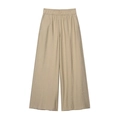 Close-up of beige wide-leg trousers showing elastic waist and fine fabric texture - XS / Pants