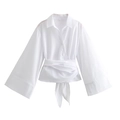 White wrap-around blouse with wide waist tie and flare sleeves for a modern look - White