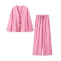 Detail of pink two-piece set featuring lace-up V-neck top with wooden beads and linen texture - Pink