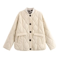 Close-up of cream quilted jacket featuring leopard print lining and contrast buttons - S / Off White