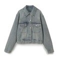 Detailed view of light blue denim jacket featuring distressed rips and metal buttons - XS / Light Blue