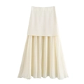 Close-up of beige layered maxi skirt featuring a pleated hem and textured fabric - S / Skirts / Milky White