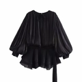 Detailed view of black satin puff sleeve top featuring elegant ruffle hem and tie-neck detail - Black