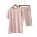 Detail of soft dusty pink lounge set featuring round neck T-shirt and loose shorts - Pink