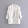Detailed view of white blazer featuring stylish pleated cuffs and shawl collar design - White