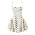 Detalle de vestido blanco de lunares con tirantes de lazo y falda con volantes - Beige Lunares
